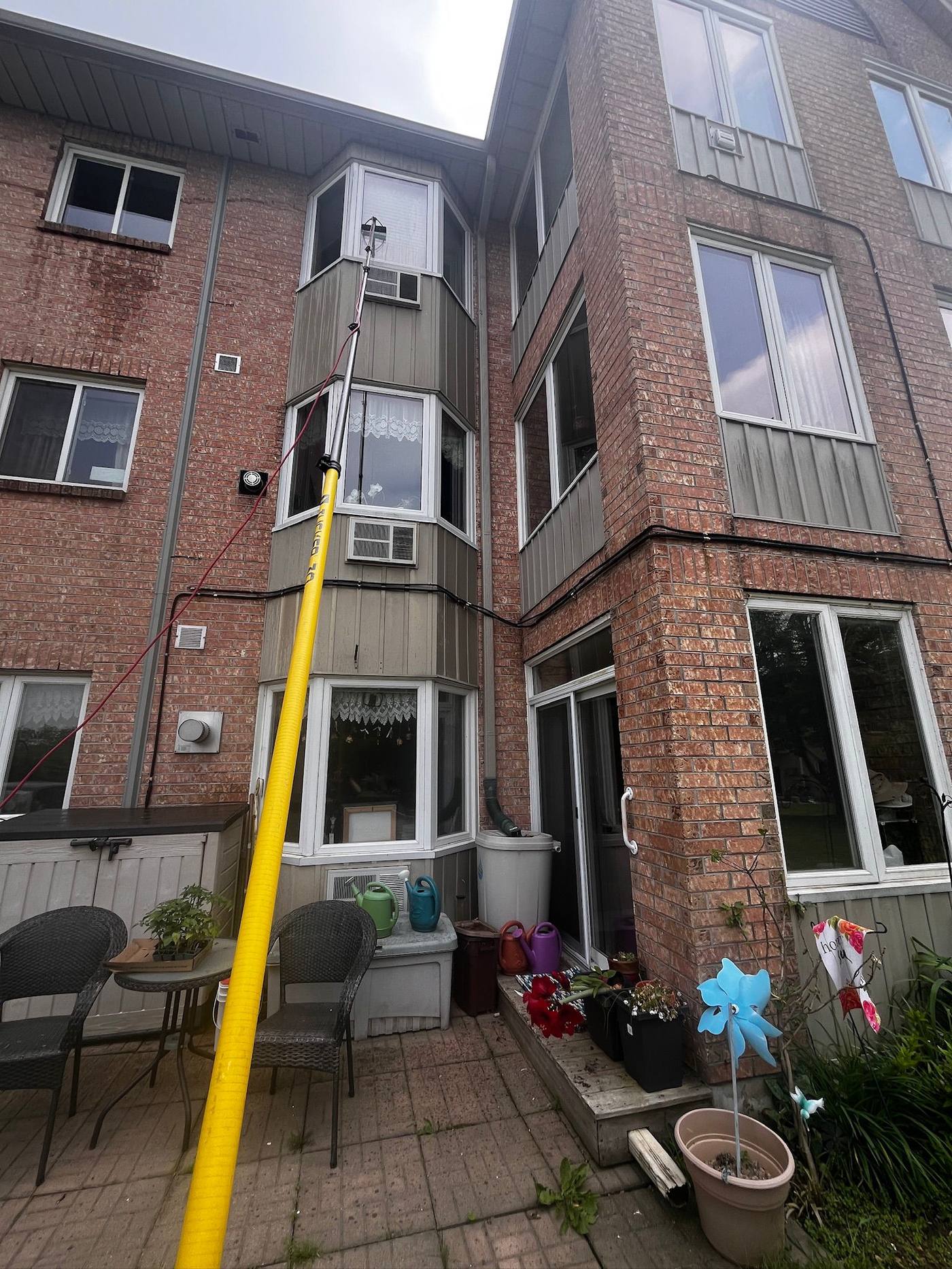 Cleaning balcony glass on an apartment building