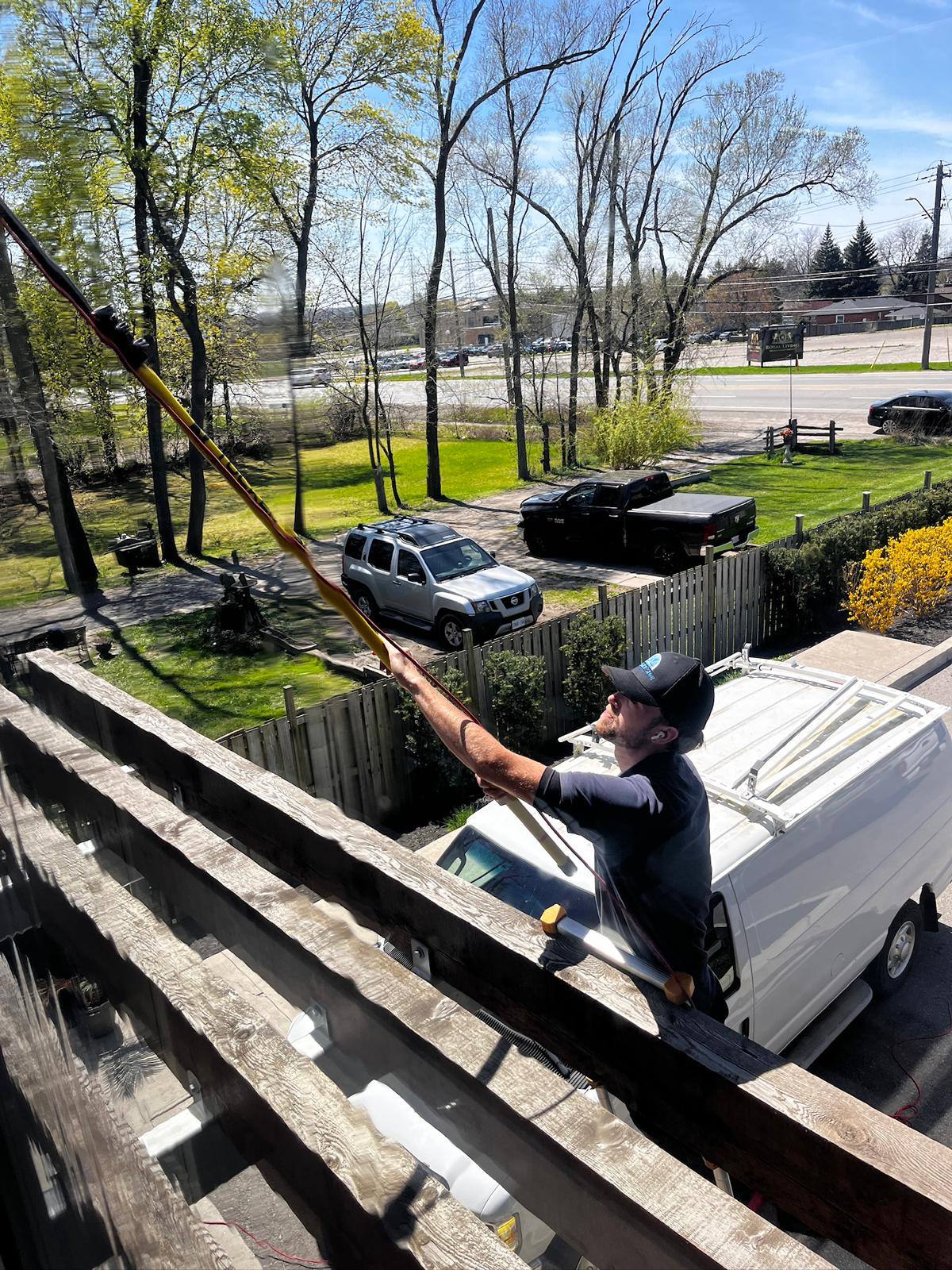 Cleaning glass from a deck overlooking the water