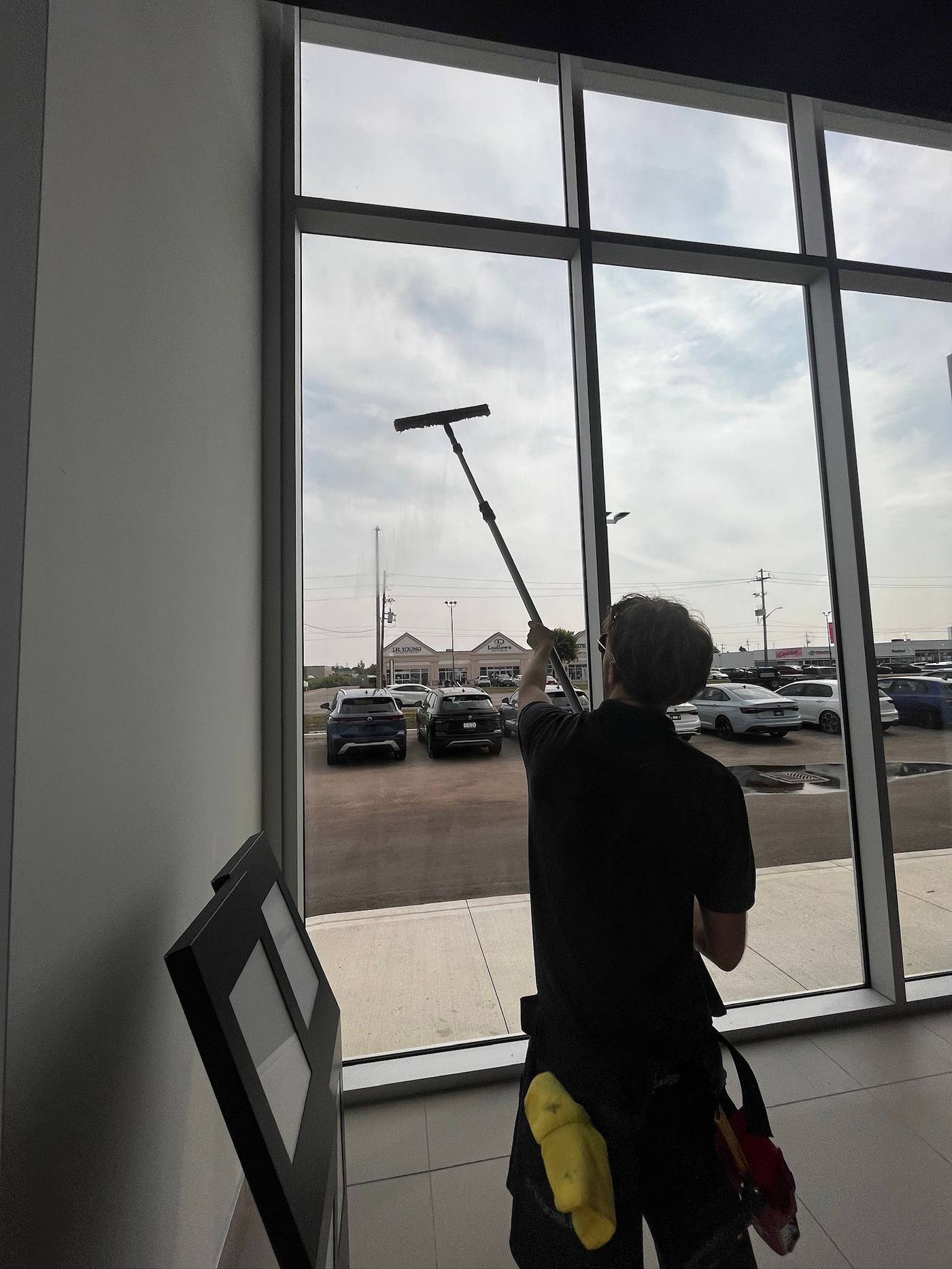 Interior showroom glass cleaned with a squeegee