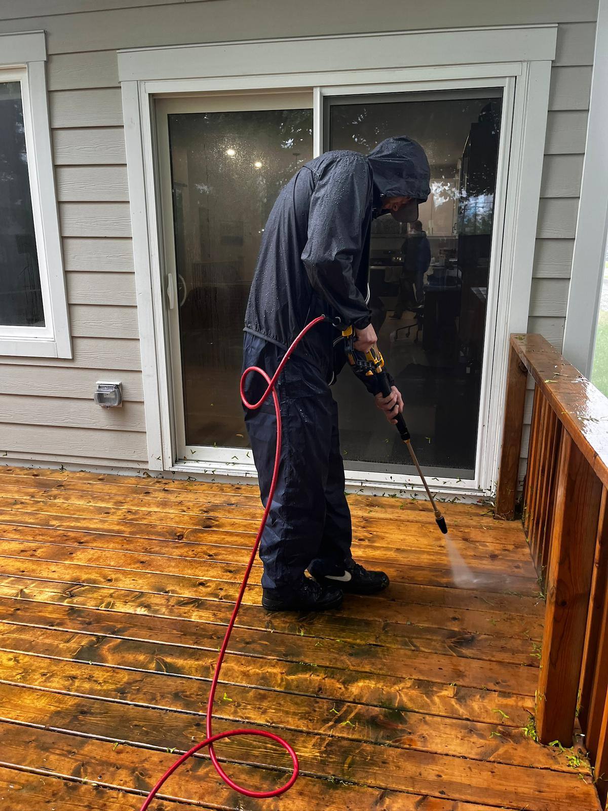 Backyard deck being pressure washed